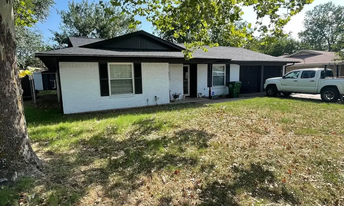 Professional roofing crew working on a residential roof in Maywood